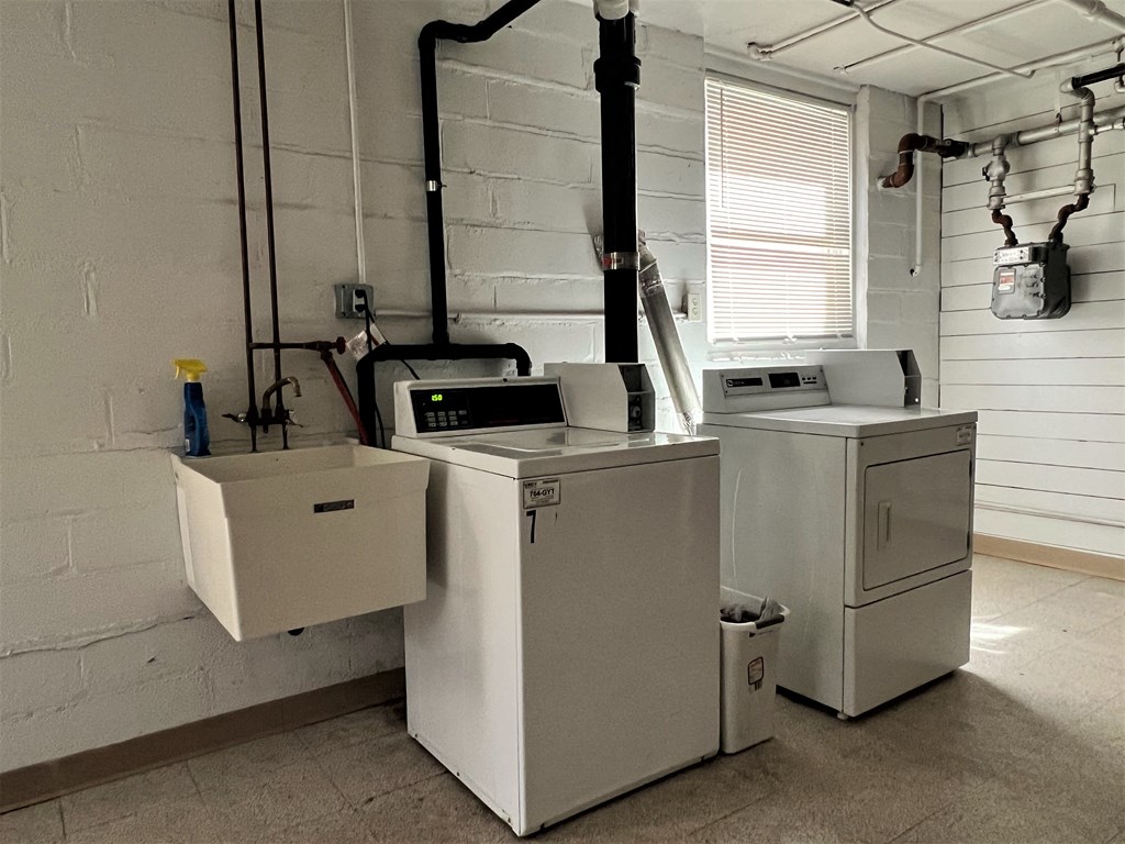 a laundry room with two washing machines and a washer and dryer