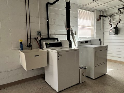 a laundry room with two washing machines and a washer and dryer