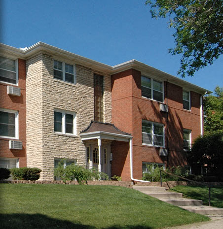 a brick building with a lawn in front of it
