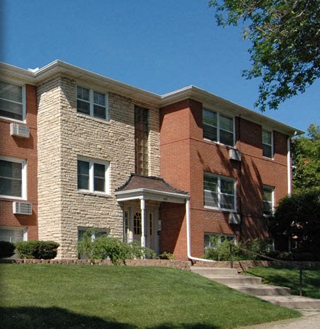 a brick building with a lawn in front of it