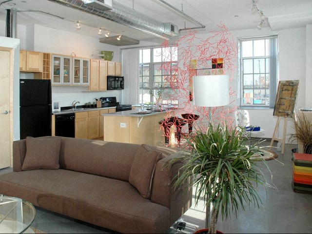 a living room with a couch and a kitchen
