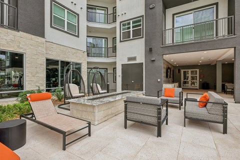 A patio area with a table, chairs and a hot tub.