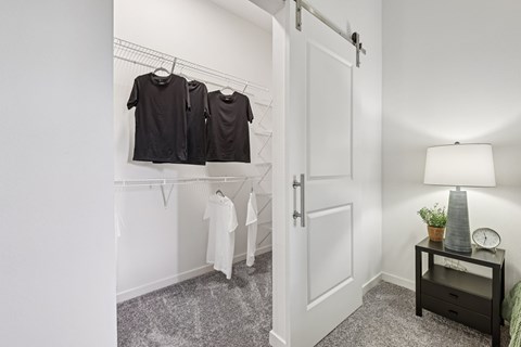 A white door is open to a room with a shelf and a lamp.