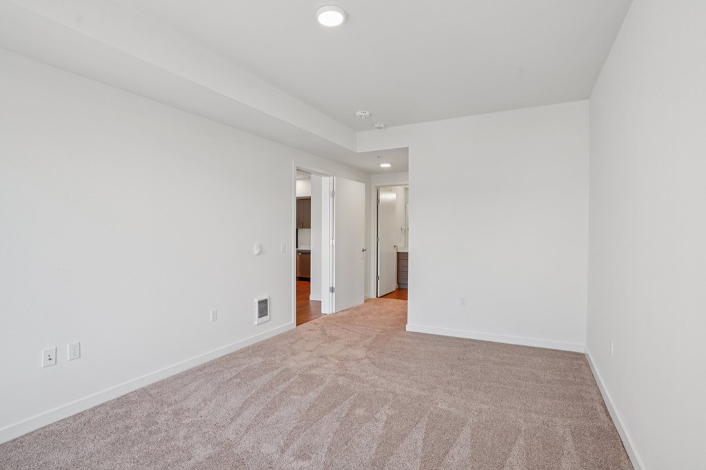 A room with a carpeted floor and white walls.