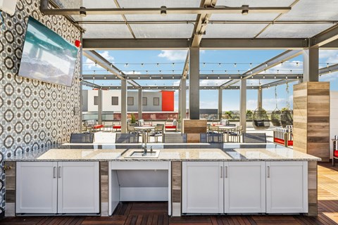 A kitchen with a large island and a view of the outdoors.