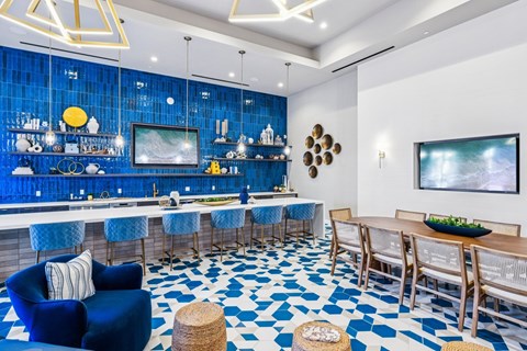 A blue and white tiled kitchen and dining room with a bar area.