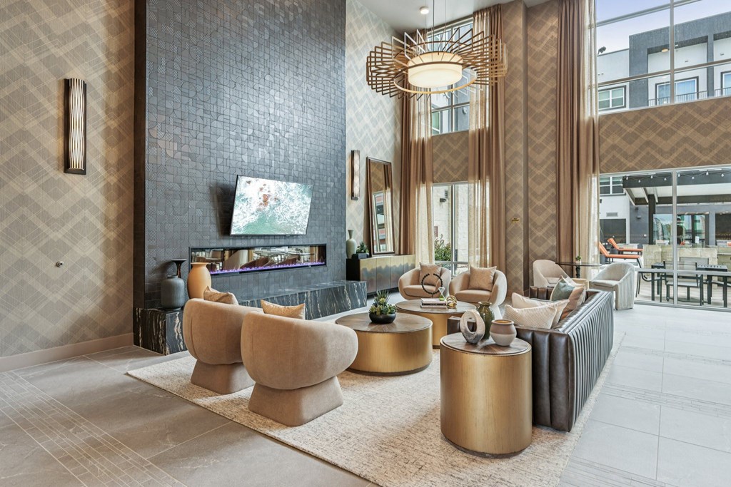 A living room with a grey and gold color scheme.