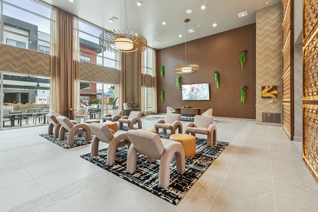 A modern waiting area with a row of chairs and a television.
