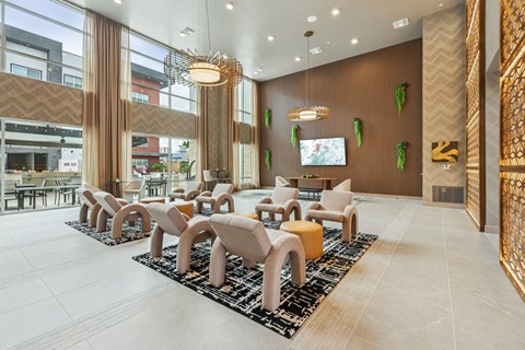 A modern waiting area with a row of chairs and a television.