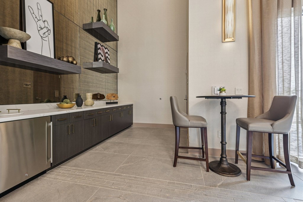 A modern kitchen with a table and chairs.