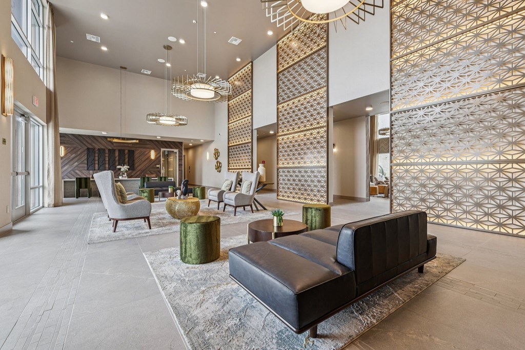 A modern living room with a black leather sofa and a patterned wallpaper.