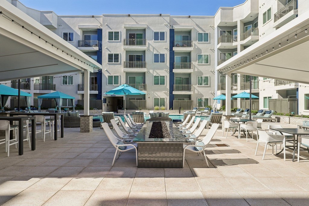 A sunny day at the poolside of a residential building.