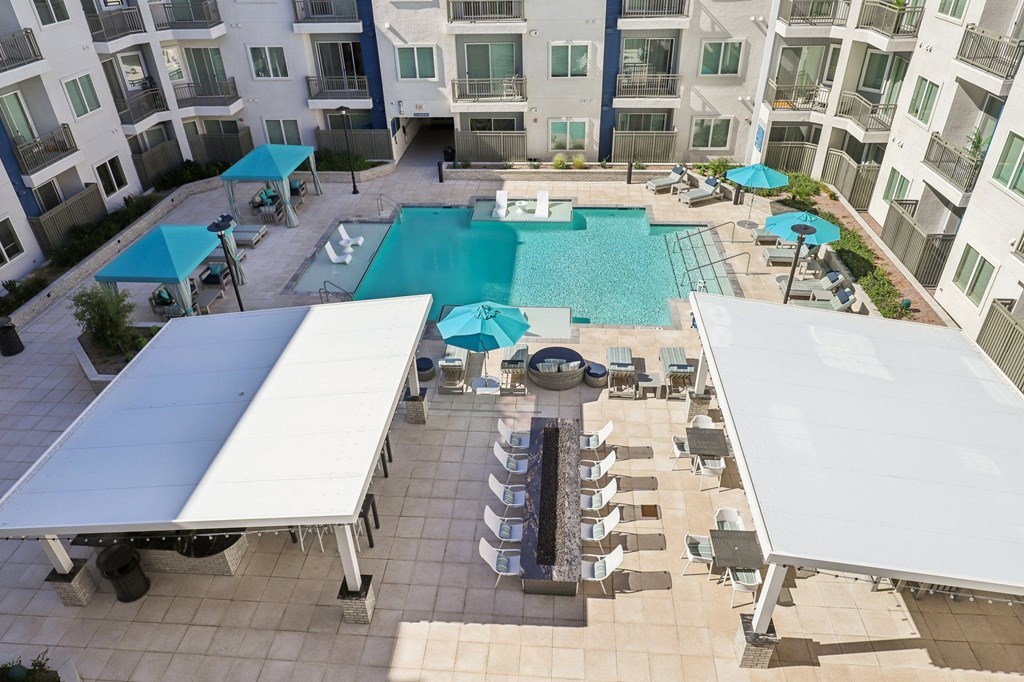 A large swimming pool surrounded by a white canopy.