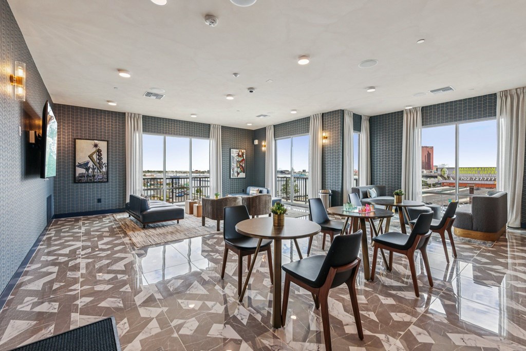 A spacious dining area with a large table surrounded by chairs.