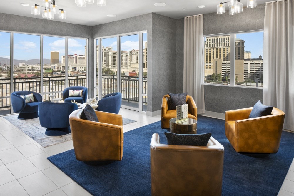 a lounge area with chairs and a view of the city at Aura Vegas Apartments, Las Vegas, Nevada