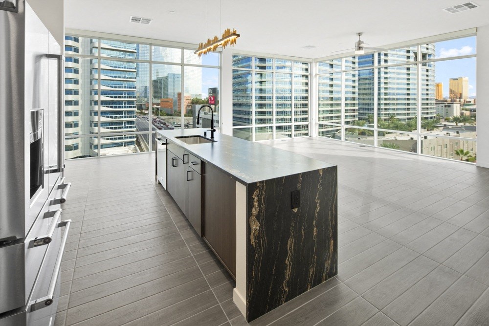 the kitchen has a large island with a view of the city at Aura Vegas Apartments, Las Vegas, Nevada