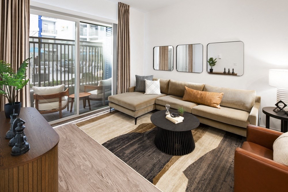 a living room with a couch and a table at Aura Vegas Apartments, Las Vegas, Nevada