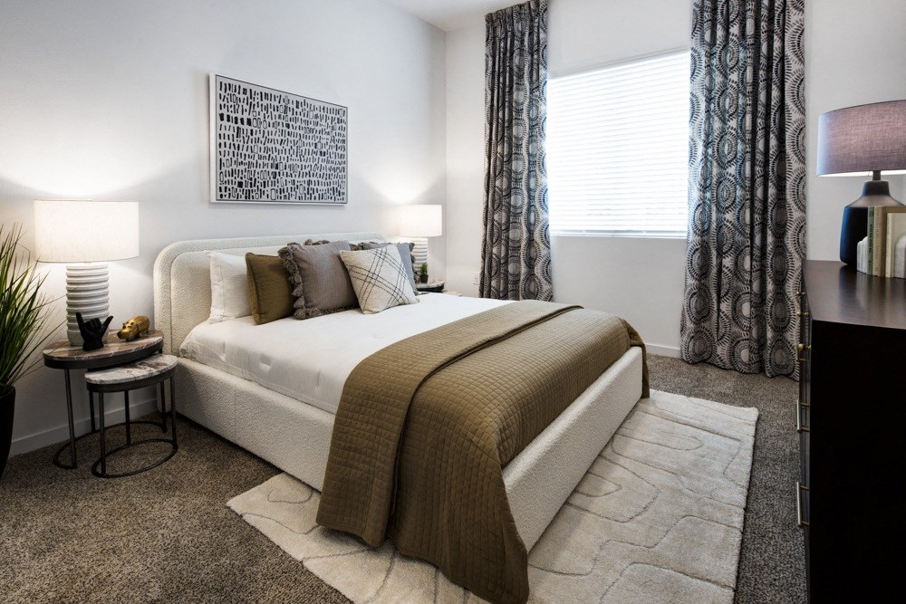 a bedroom with a bed and a window with curtains at Aura Vegas Apartments, Las Vegas, 89103