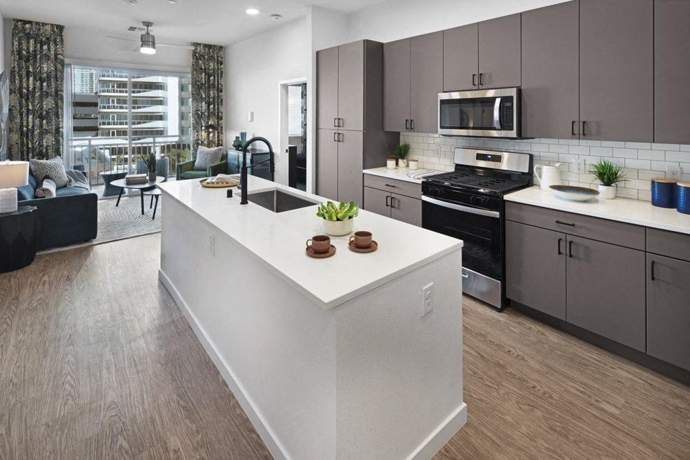 a view of a kitchen with a large island in the middle at Aura Vegas Apartments, Las Vegas, NV 89103