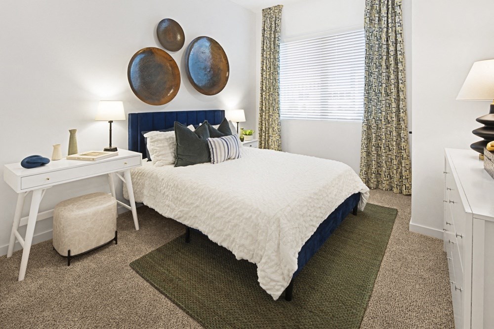 a bedroom with a bed and a desk and a window at Aura Vegas Apartments, Nevada, 89103