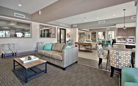 A living room with a couch, chairs, and a coffee table.
