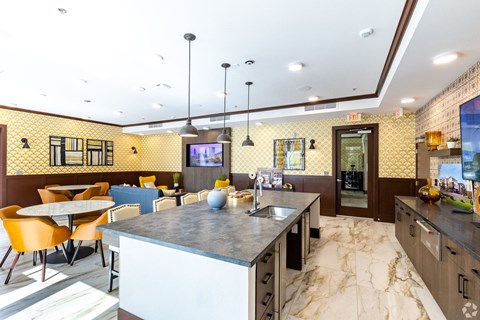 a kitchen with a large island and a table with chairs