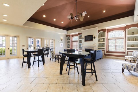 a dining room with tables and chairs and a fireplace