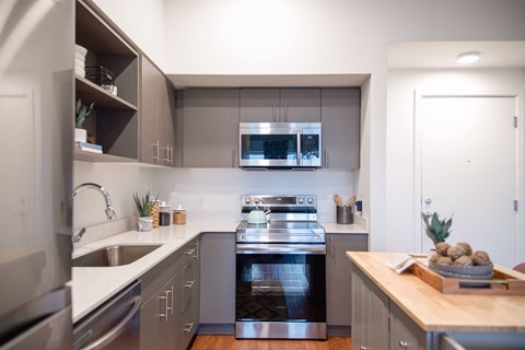 a kitchen with stainless steel appliances and a stove top oven