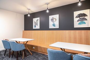 a meeting room with two tables and four chairs at Hana Apartments, Hillsboro