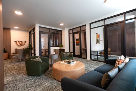 A living room with a green couch and a wooden coffee table.