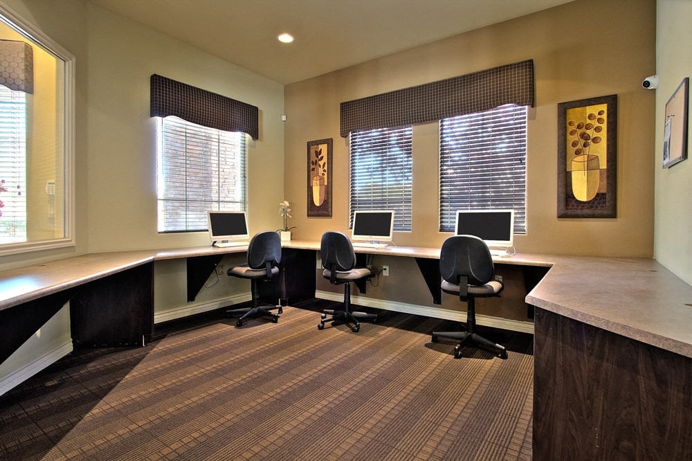 a large office area with desks and chairs and computers