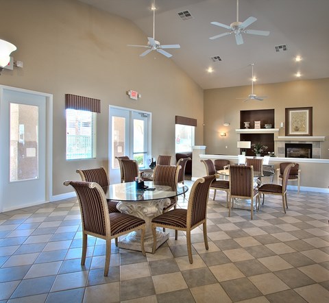 A dining room with a checkered floor and a fireplace.