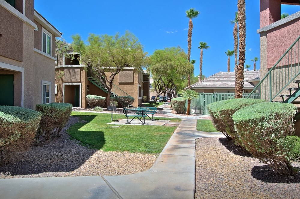 a courtyard with a picnic table in front of a building