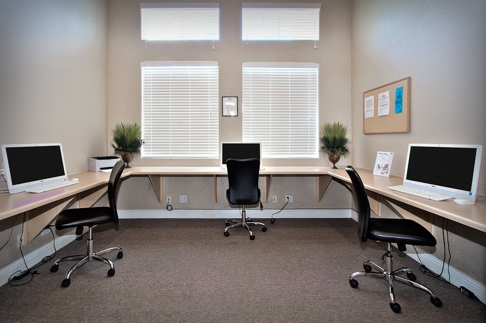 an office with two computers and a desk
