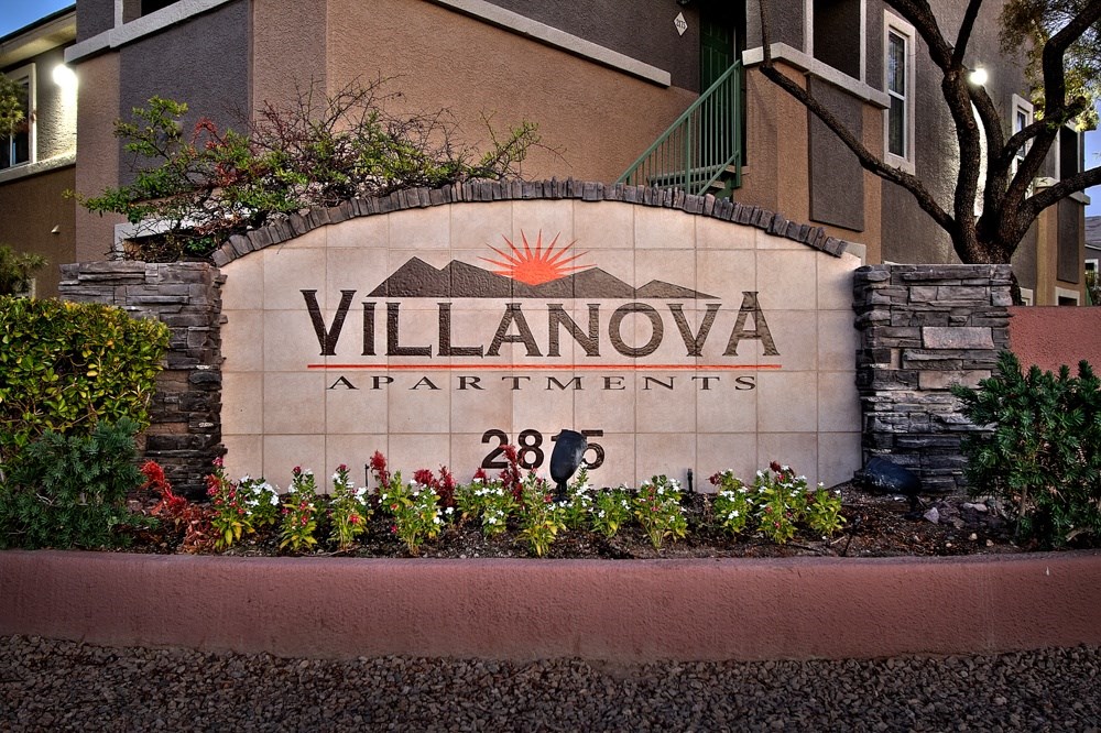 a sign for villaova apartments in front of a building