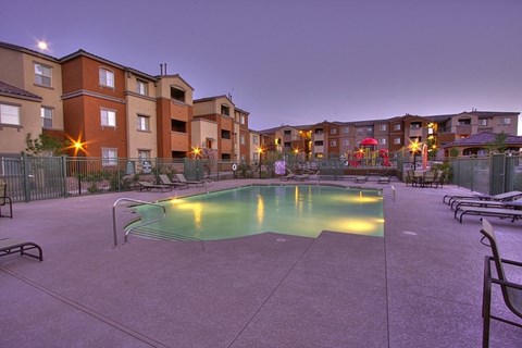 A swimming pool in a courtyard surrounded by apartment buildings.