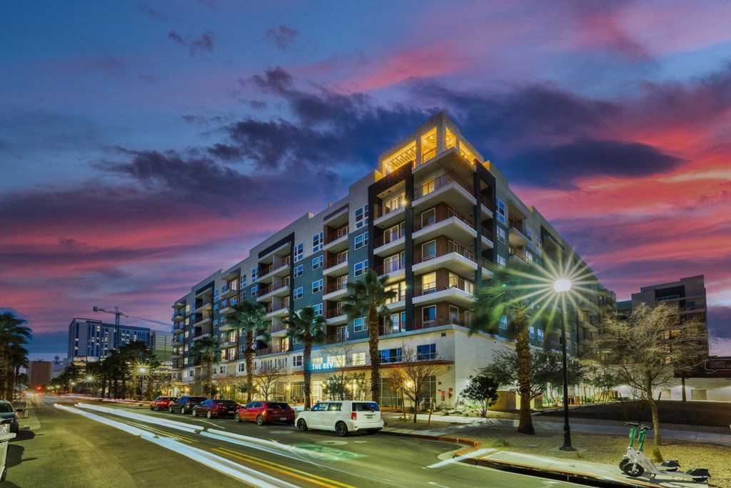 a large building with a pink and purple sky in the background at The Rey Downtown, Arizona