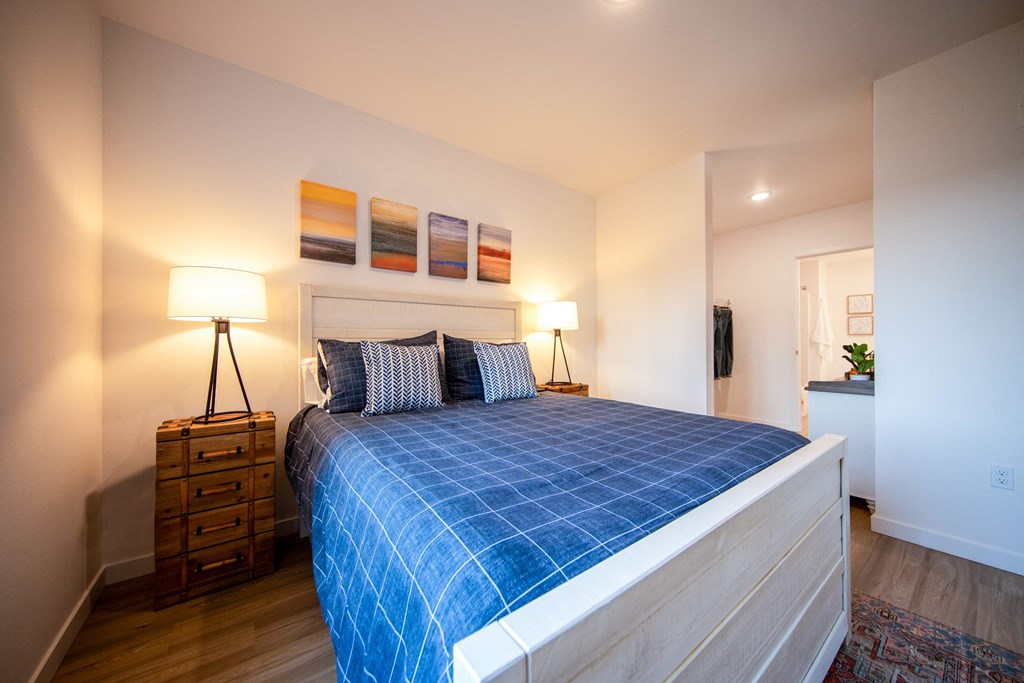 a bedroom with a bed and a blue blanketat Scouter's Mountain, Happy Valley, OR 97086