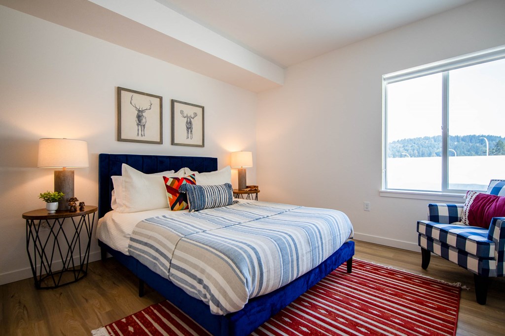 a bedroom with a bed and two chairsat Scouter's Mountain, Oregon, 97086