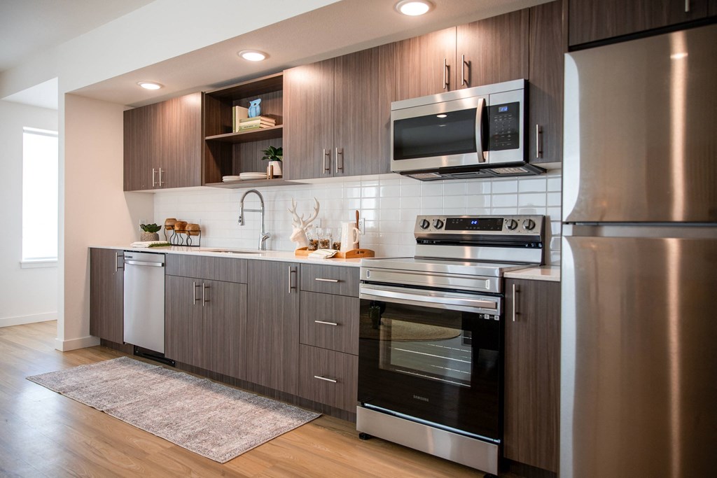 a kitchen with stainless steel appliances and wooden cabinetsat Scouter's Mountain, Happy Valley