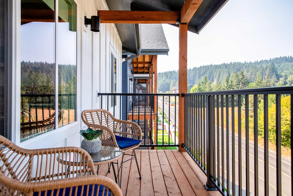 a balcony with chairs and a table at Scouter's Mountain, Oregon