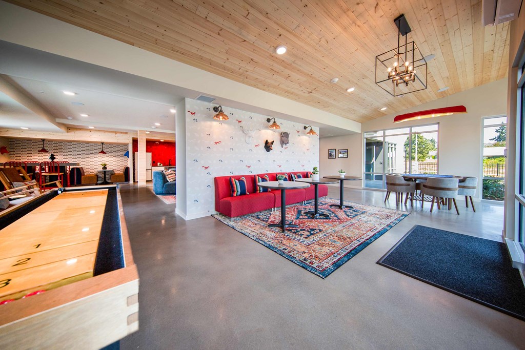 a large living room with a red couch and a dining room tableat Scouter's Mountain, Happy Valley, OR