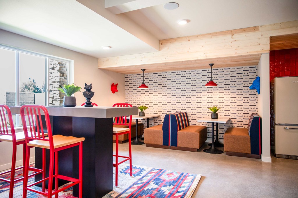 a kitchen and living room with red chairs and a white brick wall at Scouter's Mountain, Oregon, 97086