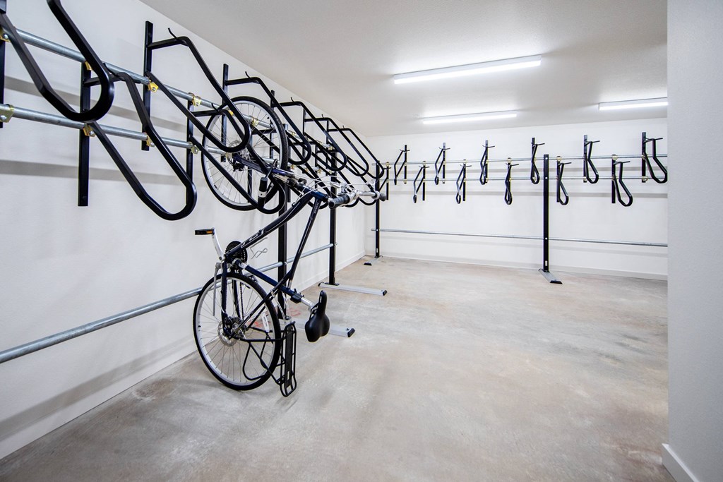 a row of bikes hanging from a wall in a white roomat Scouter's Mountain, Happy Valley