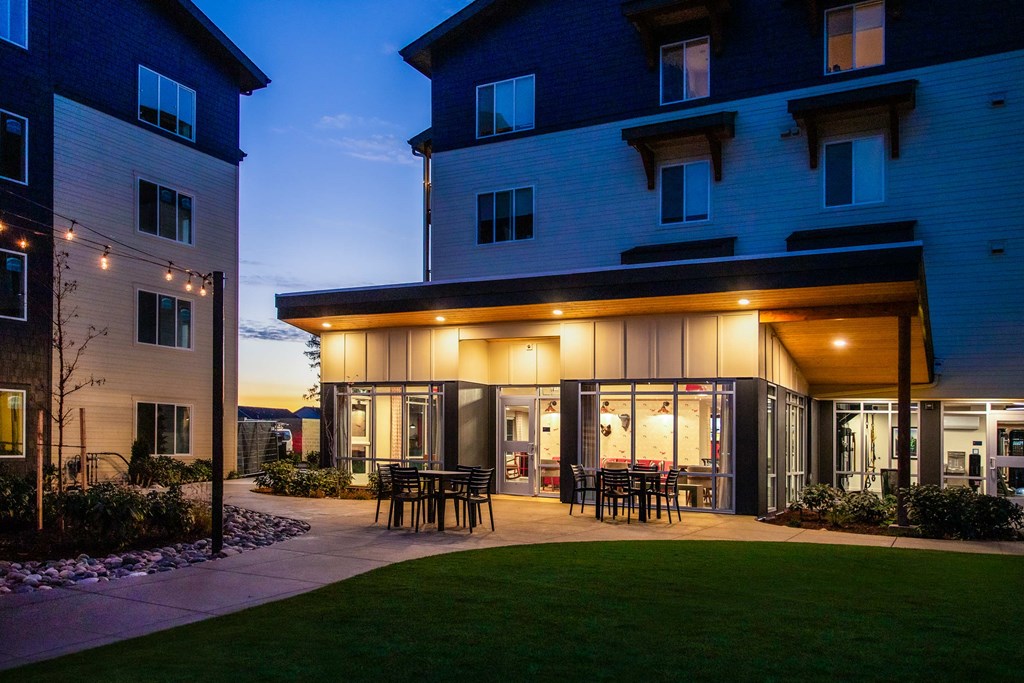 a patio with tables and chairs outside of a building at nightat Scouter's Mountain, Happy Valley, OR