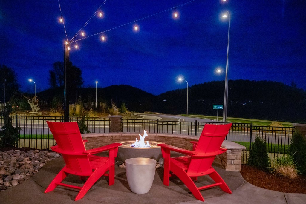two red chairs around a fire pit on a patio at nightat Scouter's Mountain, Happy Valley, 97086