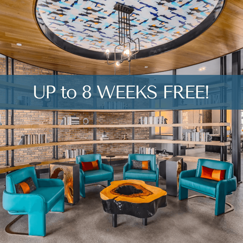 the lobby of a library with blue chairs and a yellow table