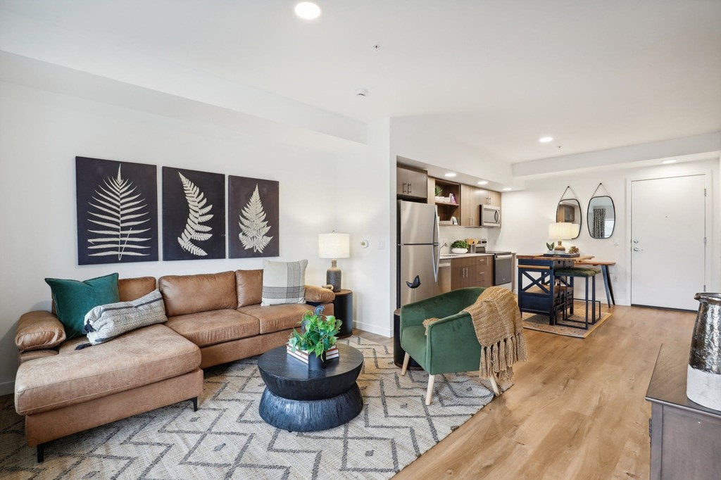 a modern, spacious living room with a couch and a table at The Mill on Maple Apartments, Oregon, 97045