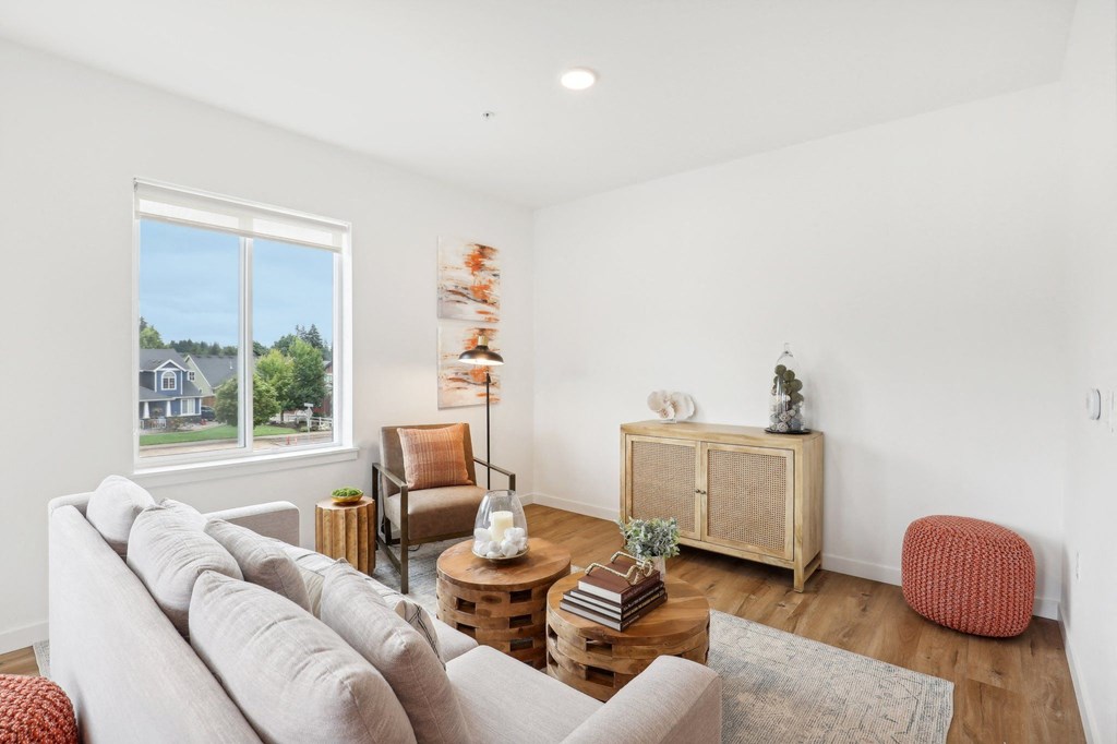 a living room with a couch and a window at The Mill on Maple Apartments, Oregon City, OR