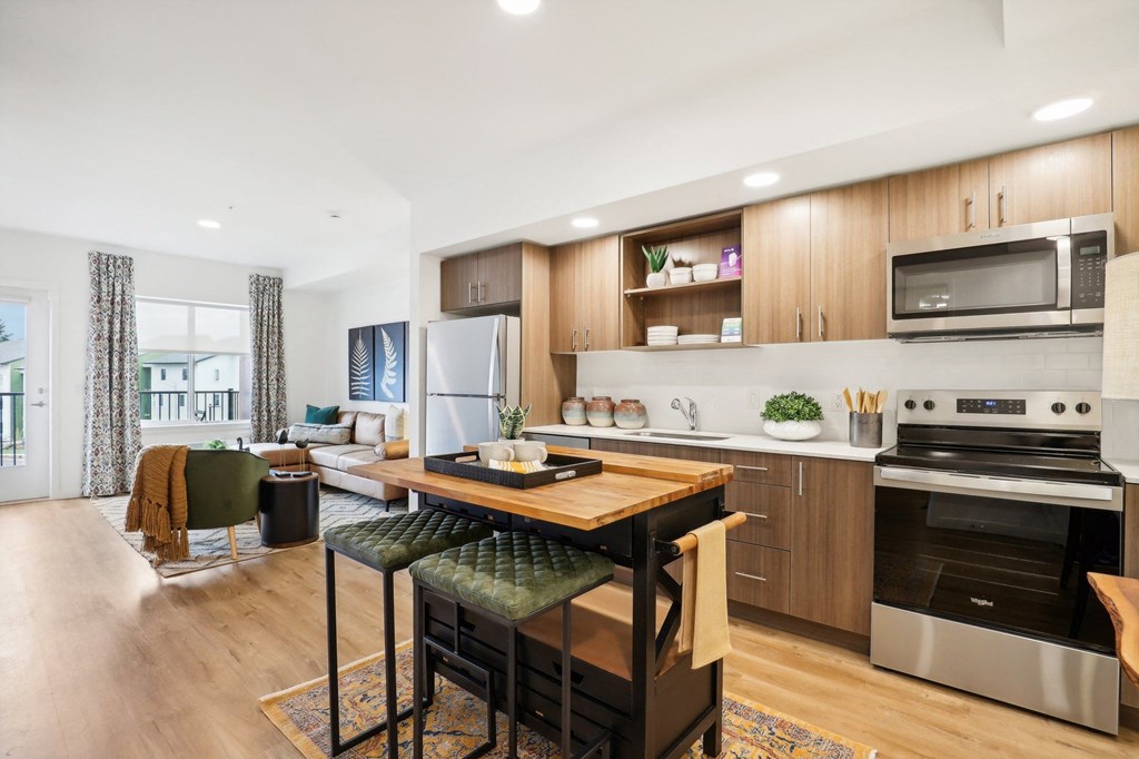 an open kitchen and living room with a table and chairs at The Mill on Maple Apartments, Oregon, 97045